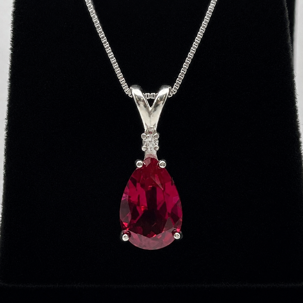 7.5ct Pear Cut Ruby Pendant Necklace with White Sapphire Accent in Sterling Silver