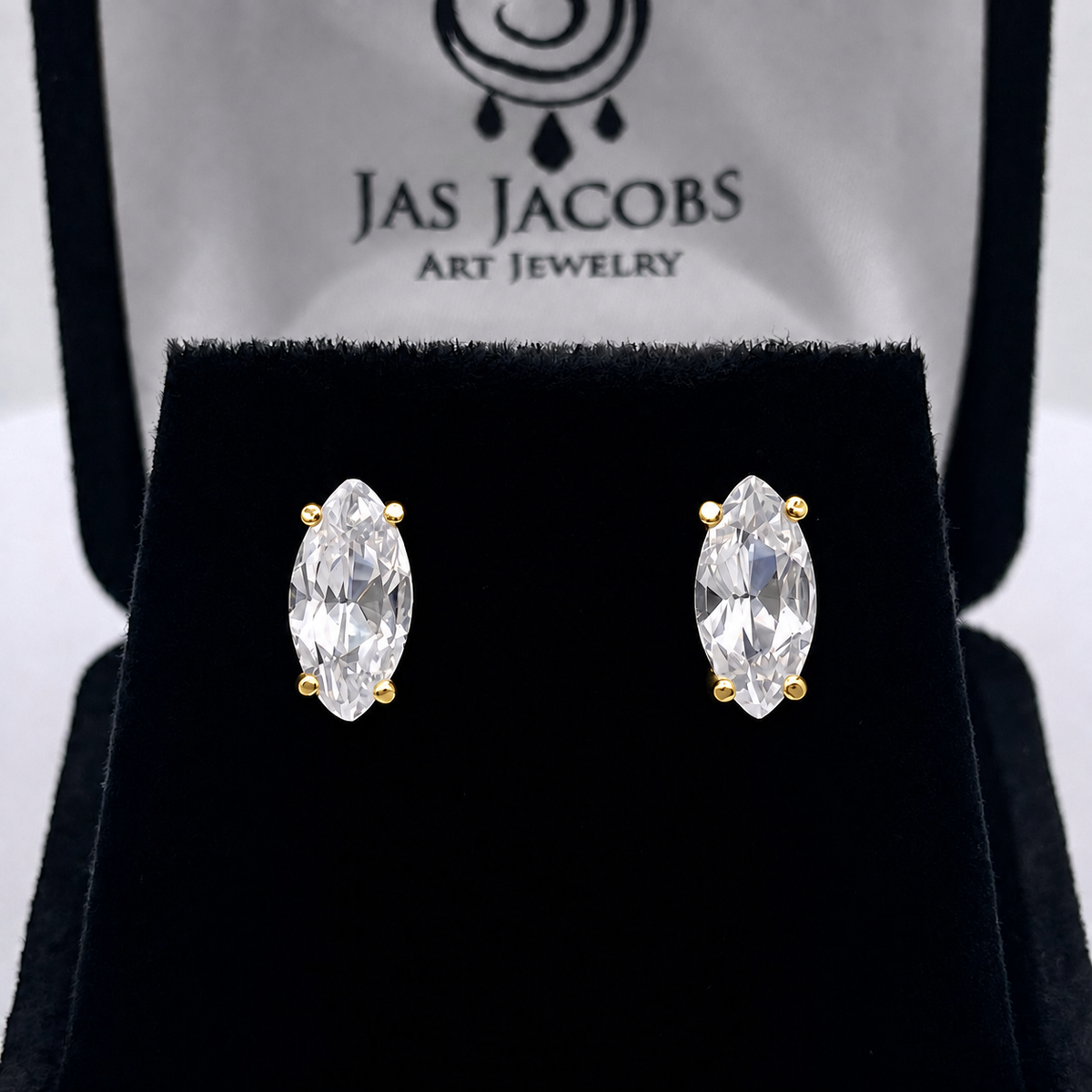 Front view of Marquise White Sapphire stud earrings in Yellow Gold displayed on black velvet