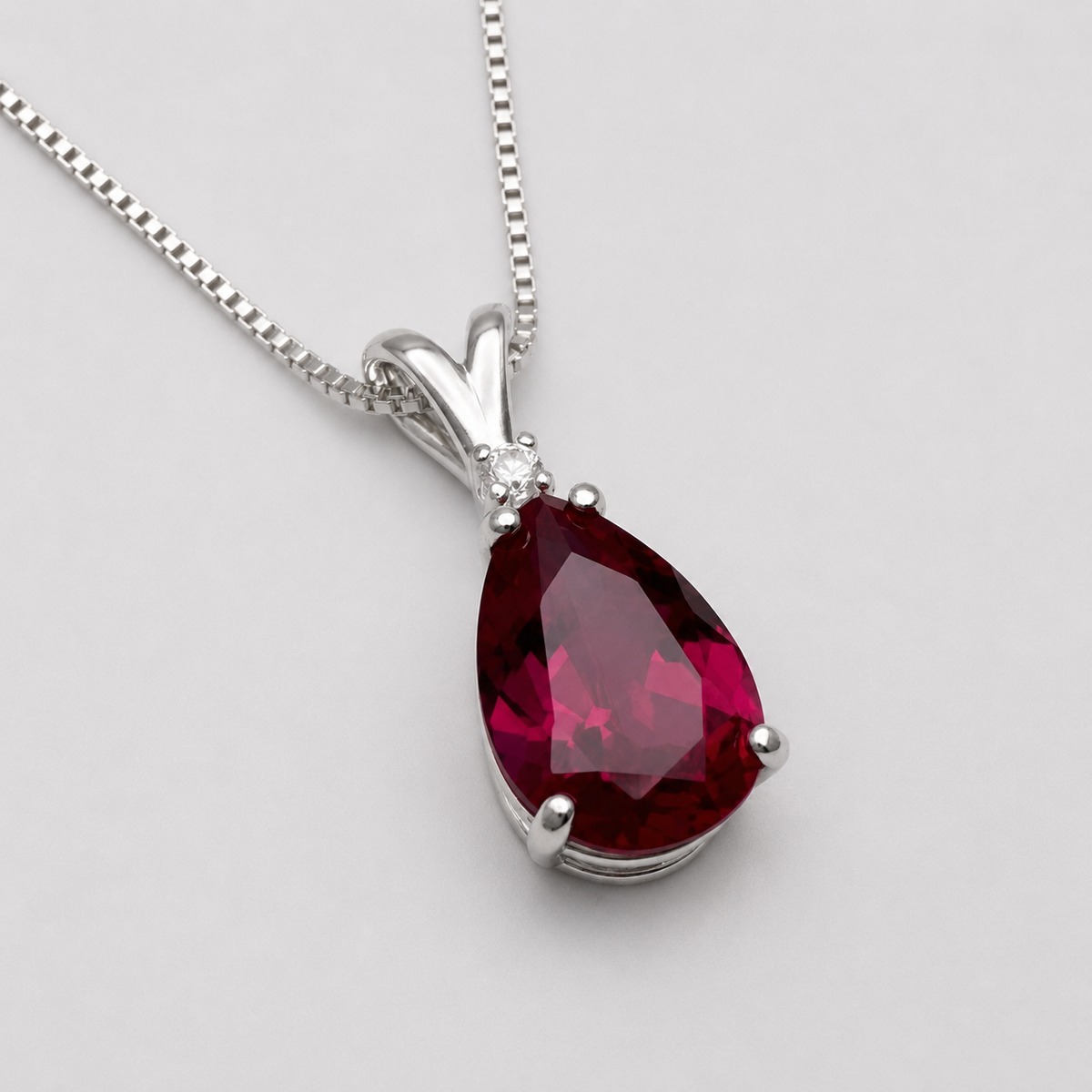 7.5ct Pear Cut Ruby Pendant Necklace with White Sapphire Accent in Sterling Silver