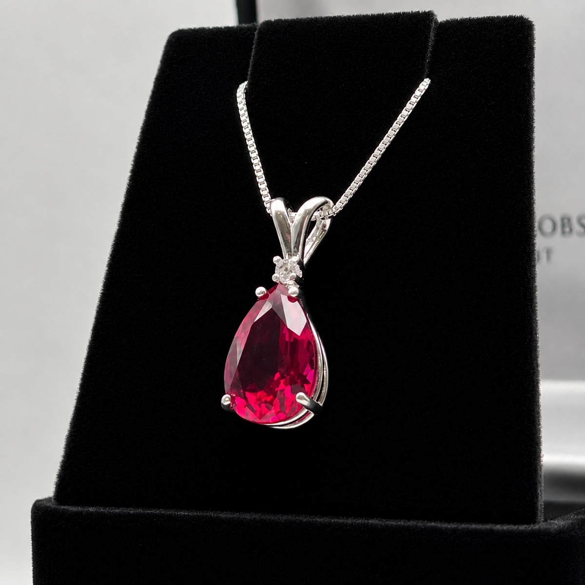 7.5ct Pear Cut Ruby Pendant Necklace with White Sapphire Accent in Sterling Silver