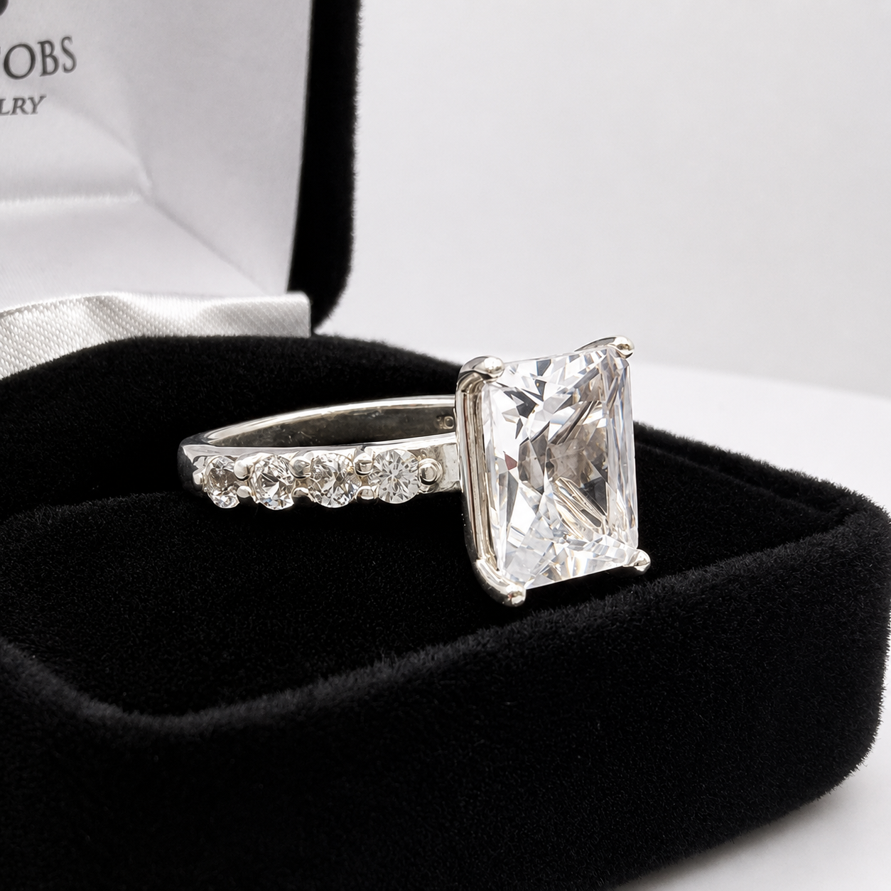 4CT Emerald Cut White Sapphire Ring | 0.64 CTW Diamond Accent Engagement Ring