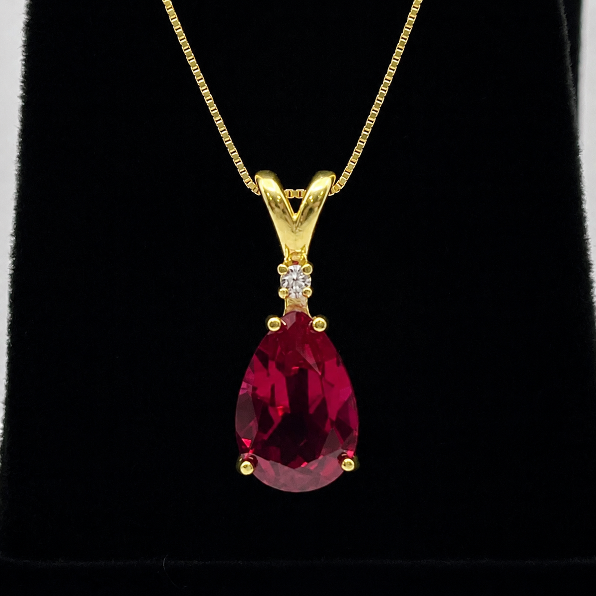 7.5ct Pear Cut Ruby Pendant Necklace with Diamond Accent in 14k Gold