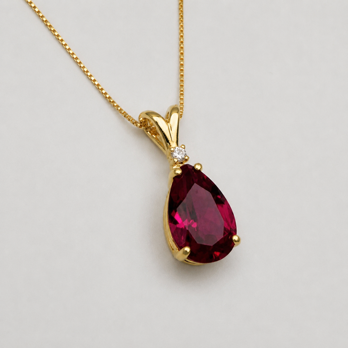 7.5ct Pear Cut Ruby Pendant Necklace with Diamond Accent in 14k Gold