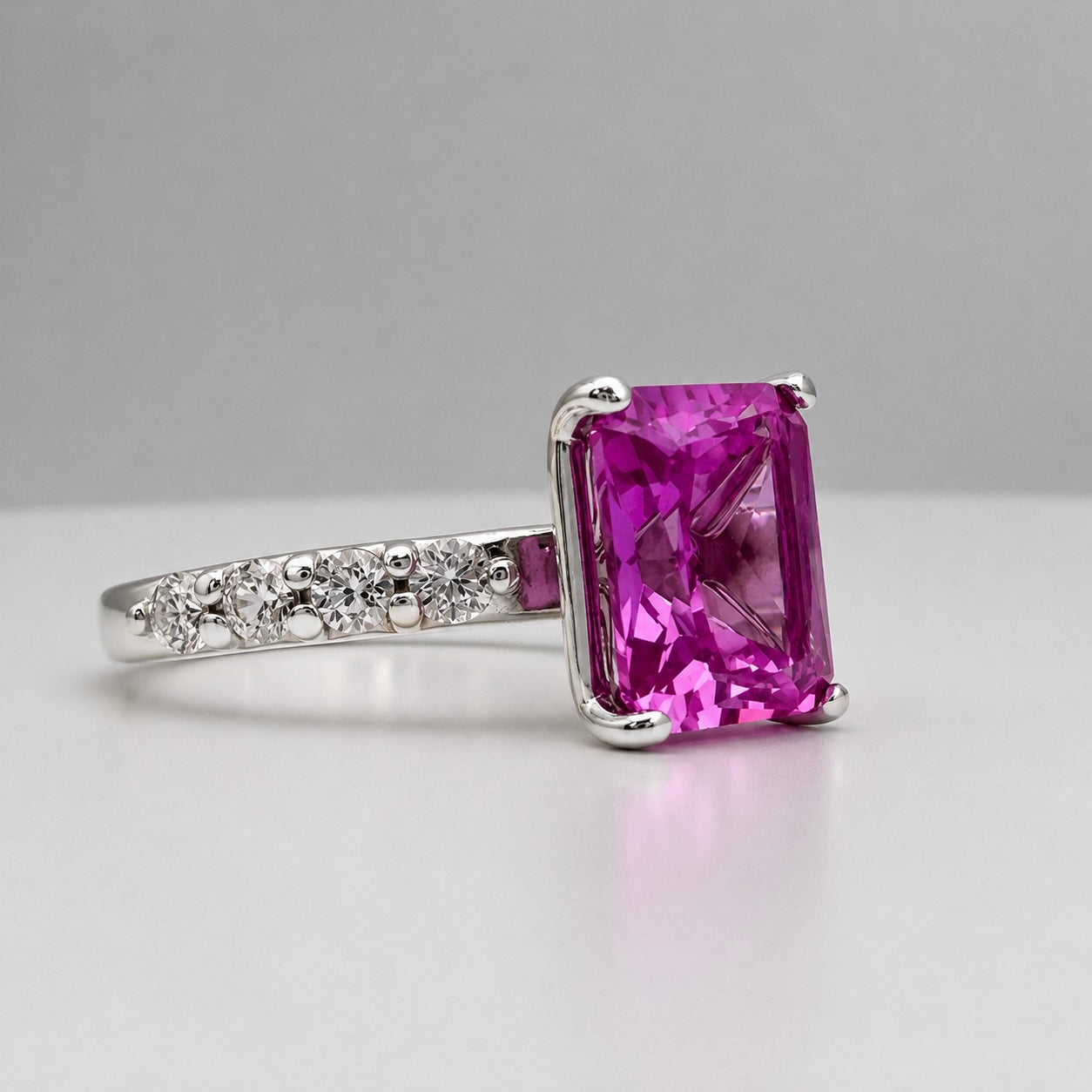 4.64CTW Emerald Cut Pink Sapphire Ring with 8 Brilliant Diamond Accents