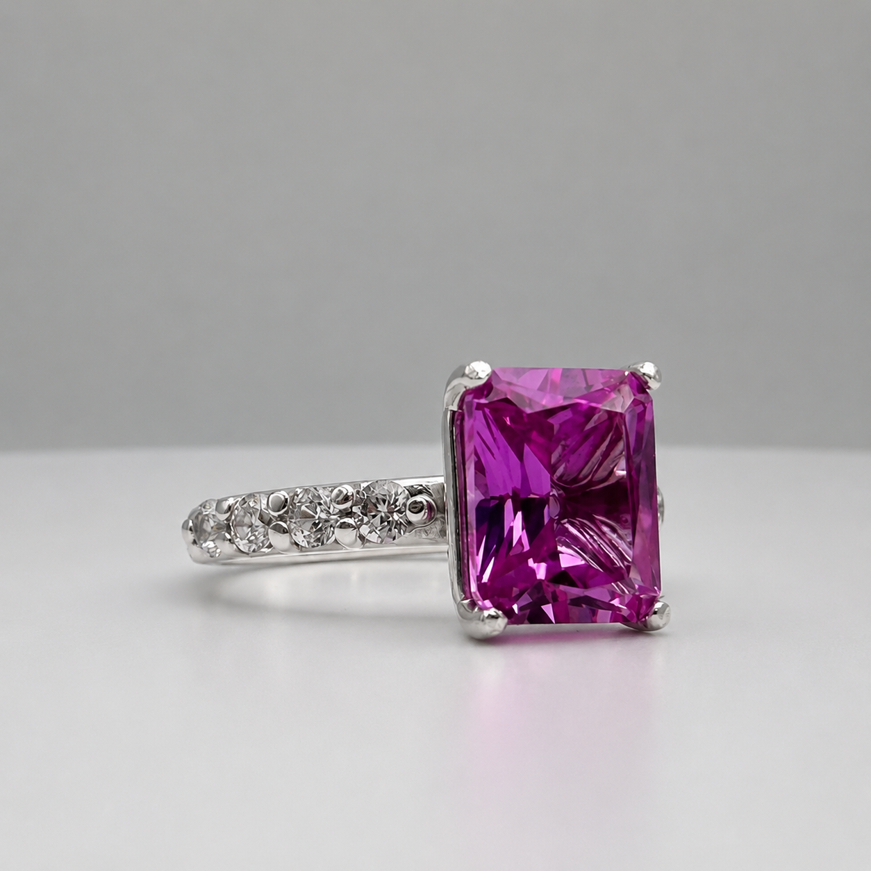 4.64CTW Emerald Cut Pink Sapphire Ring with 8 Brilliant Diamond Accents