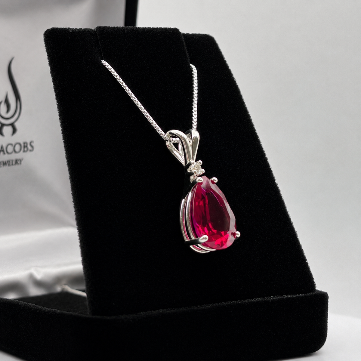 7.5ct Pear Cut Ruby Pendant Necklace with White Sapphire Accent in Sterling Silver