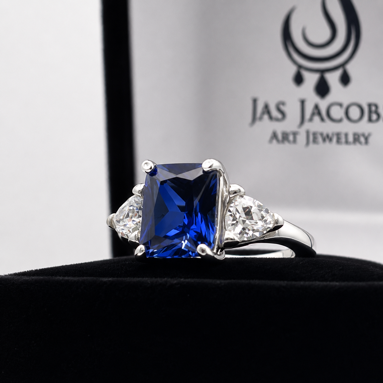 5.5ctw Emerald Cut Blue Sapphire Ring with Trillion Cut Side Stones