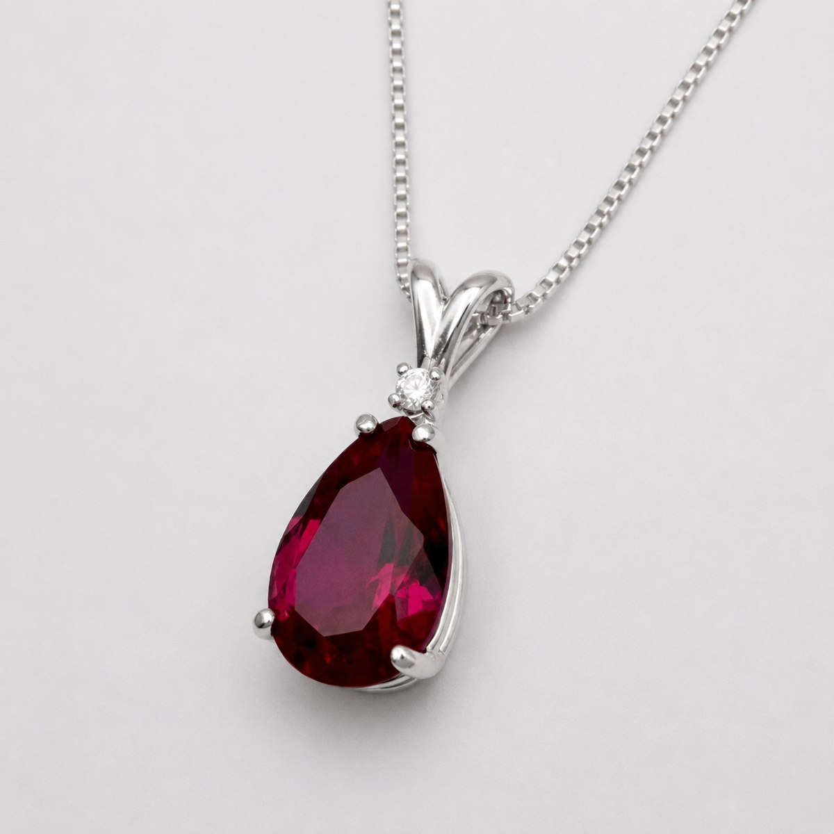 7.5ct Pear Cut Ruby Pendant Necklace with White Sapphire Accent in Sterling Silver