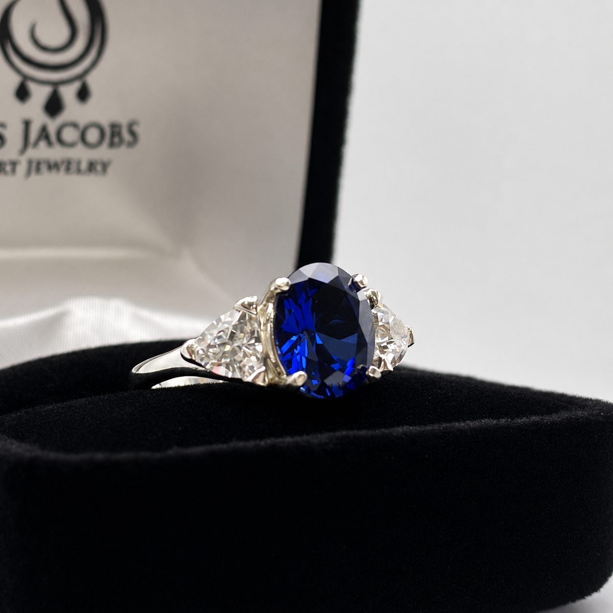 4.5ctw Oval Cut Blue Sapphire Three Stone Ring | Trillion Cut White Sapphires