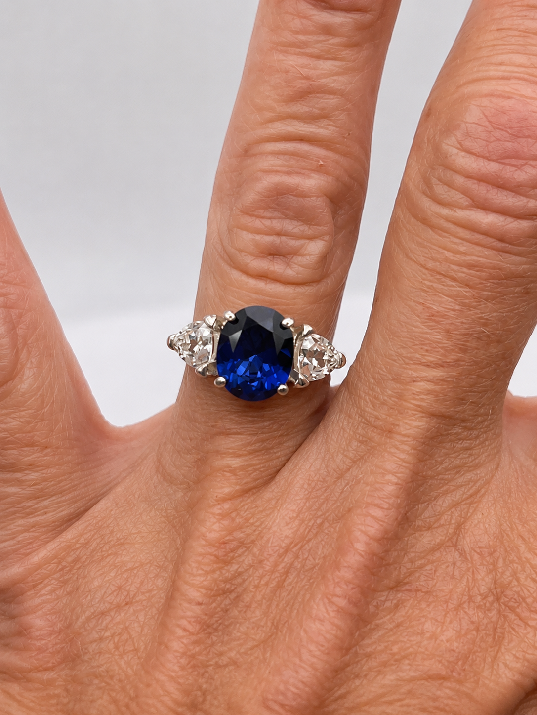 4.5ctw Oval Cut Blue Sapphire Three Stone Ring | Trillion Cut White Sapphires