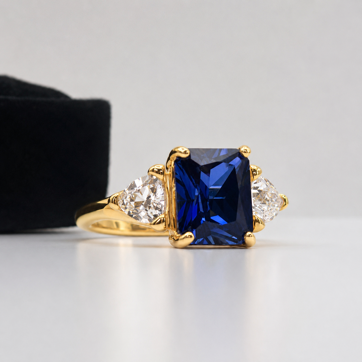5.5ctw Emerald Cut Blue Sapphire Ring with Trillion Cut Side Stones