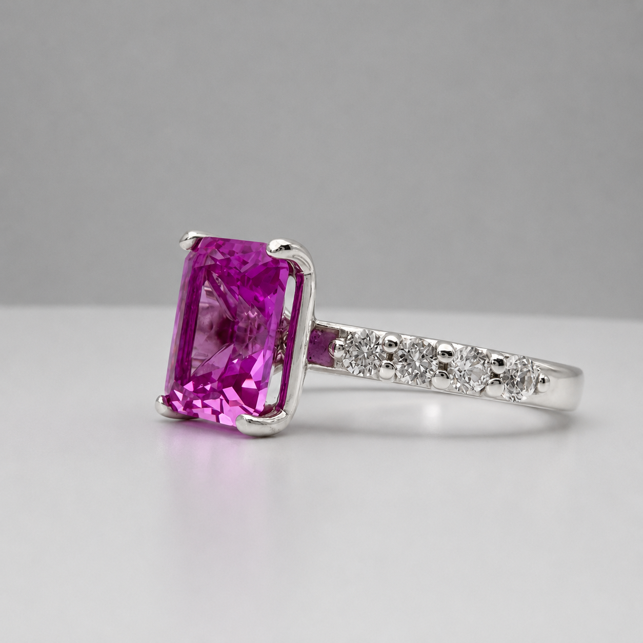 4.64CTW Emerald Cut Pink Sapphire Ring with 8 Brilliant Diamond Accents