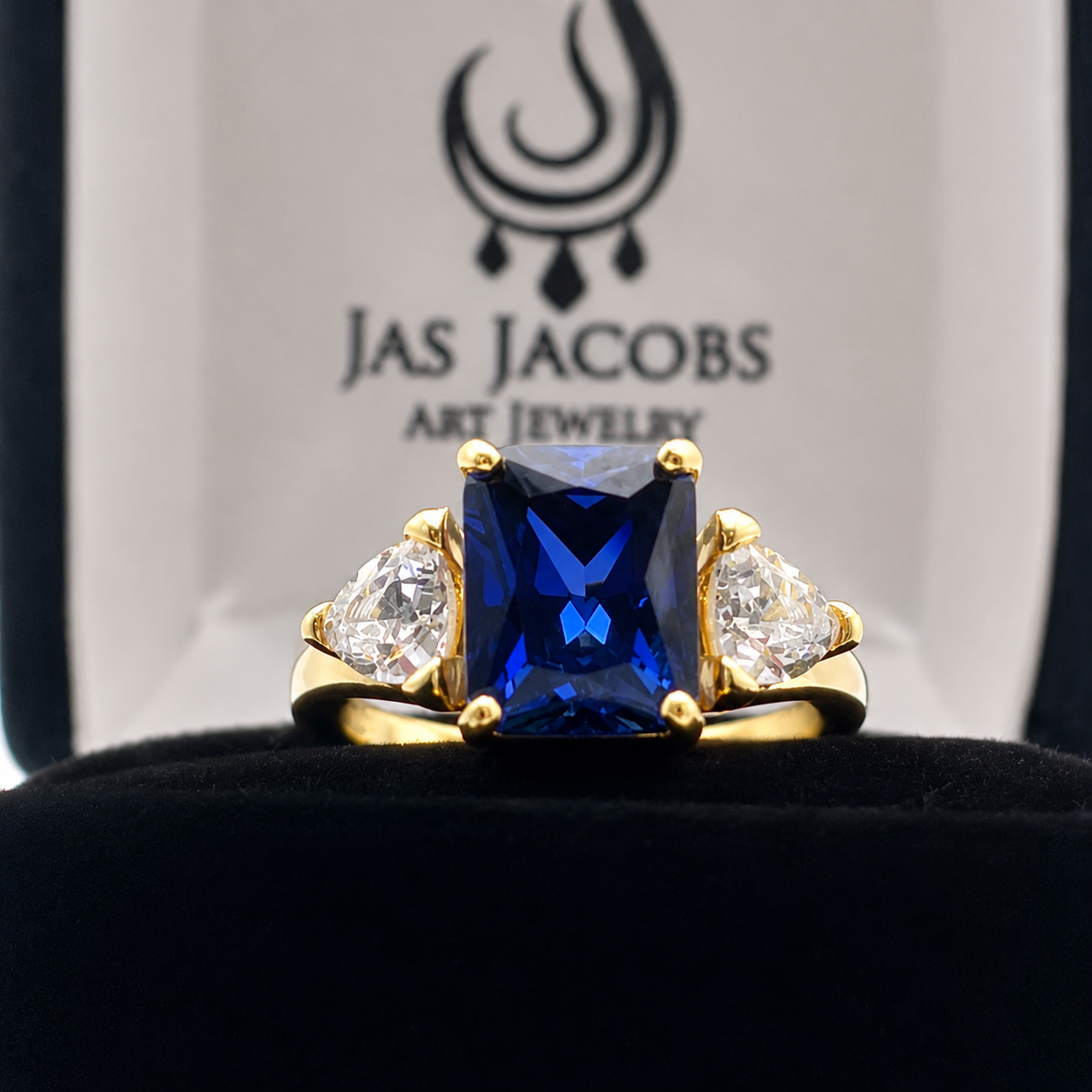 5.5ctw Emerald Cut Blue Sapphire Ring with Trillion Cut Side Stones