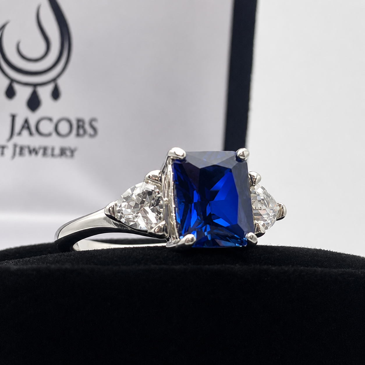 5.5ctw Emerald Cut Blue Sapphire Ring with Trillion Cut Side Stones