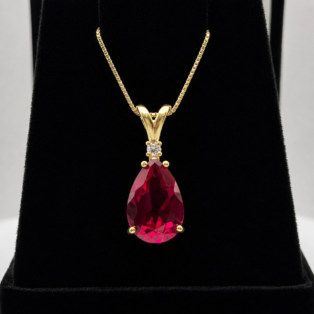 7.5ct Pear Cut Ruby Pendant Necklace with Diamond Accent in 14k Gold