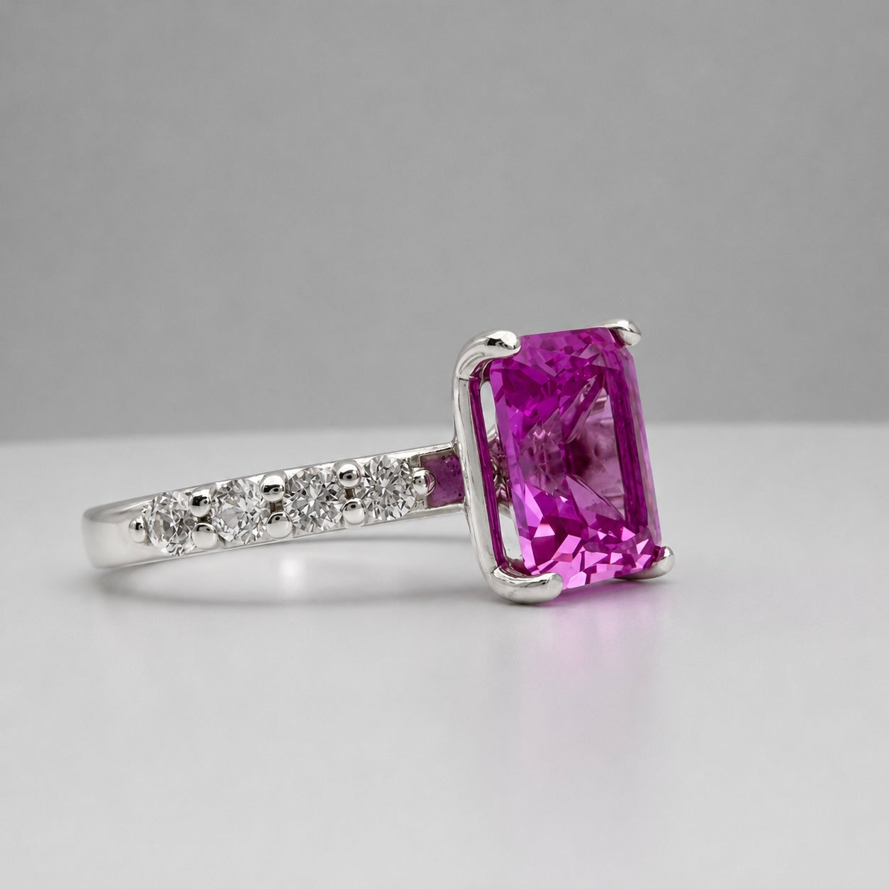 4.64CTW Emerald Cut Pink Sapphire Ring with 8 Brilliant Diamond Accents