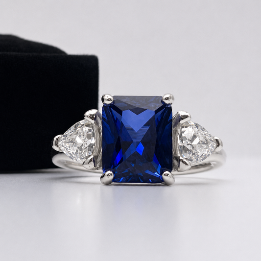 5.5ctw Emerald Cut Blue Sapphire Ring with Trillion Cut Side Stones