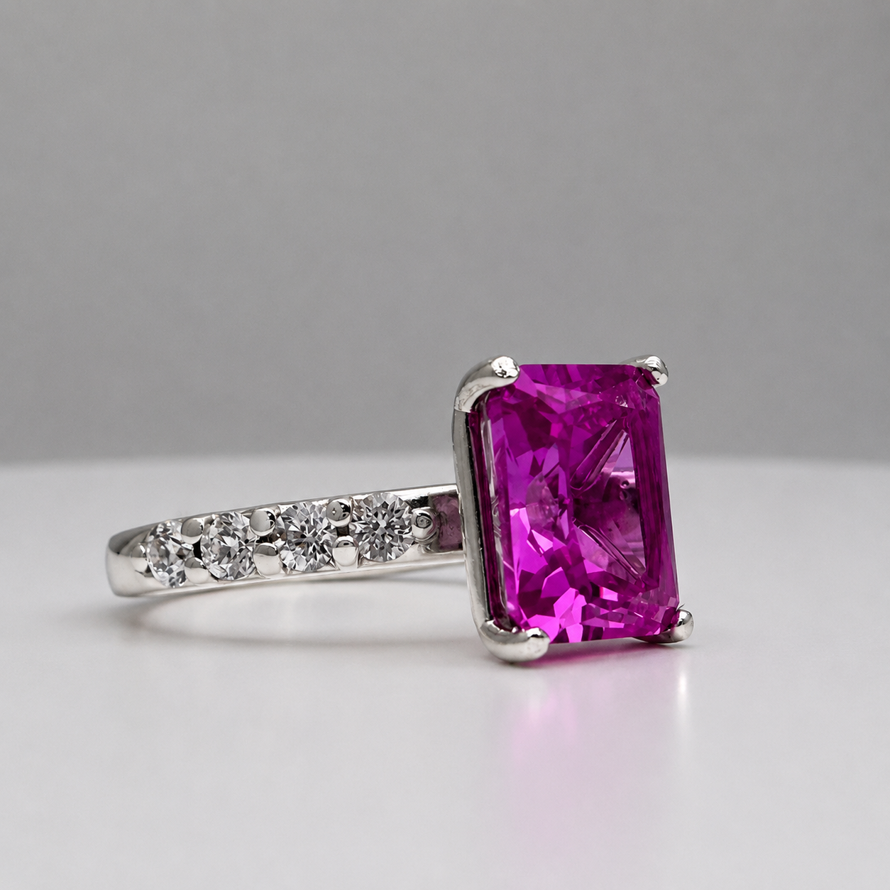 4.64CTW Emerald Cut Pink Sapphire Ring with 8 Brilliant Diamond Accents