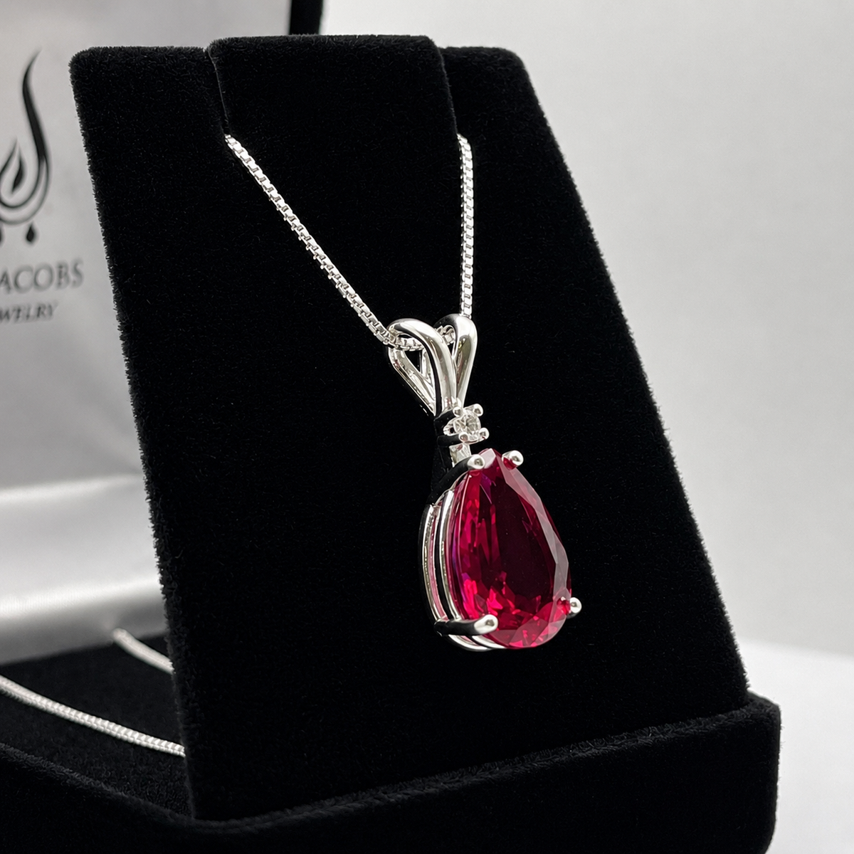 7.5ct Pear Cut Ruby Pendant Necklace with White Sapphire Accent in Sterling Silver