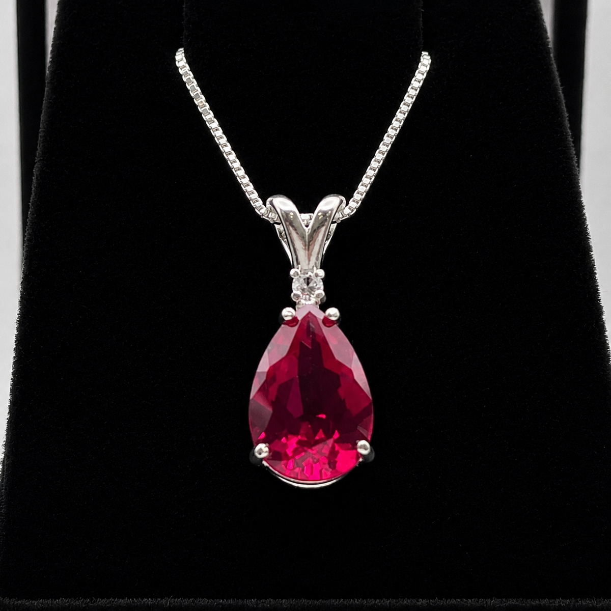 7.5ct Pear Cut Ruby Pendant Necklace with White Sapphire Accent in Sterling Silver