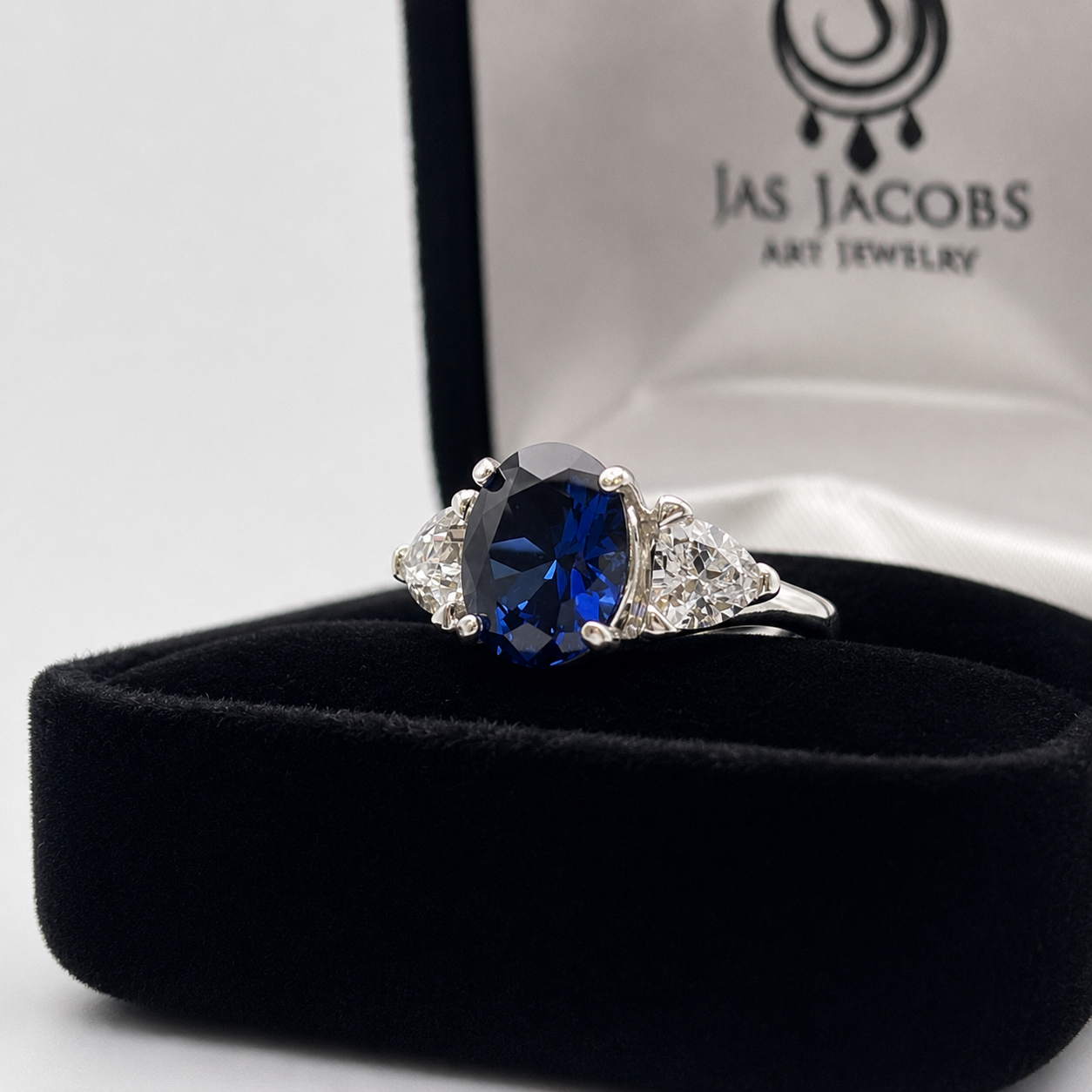 4.5ctw Oval Cut Blue Sapphire Three Stone Ring | Trillion Cut White Sapphires
