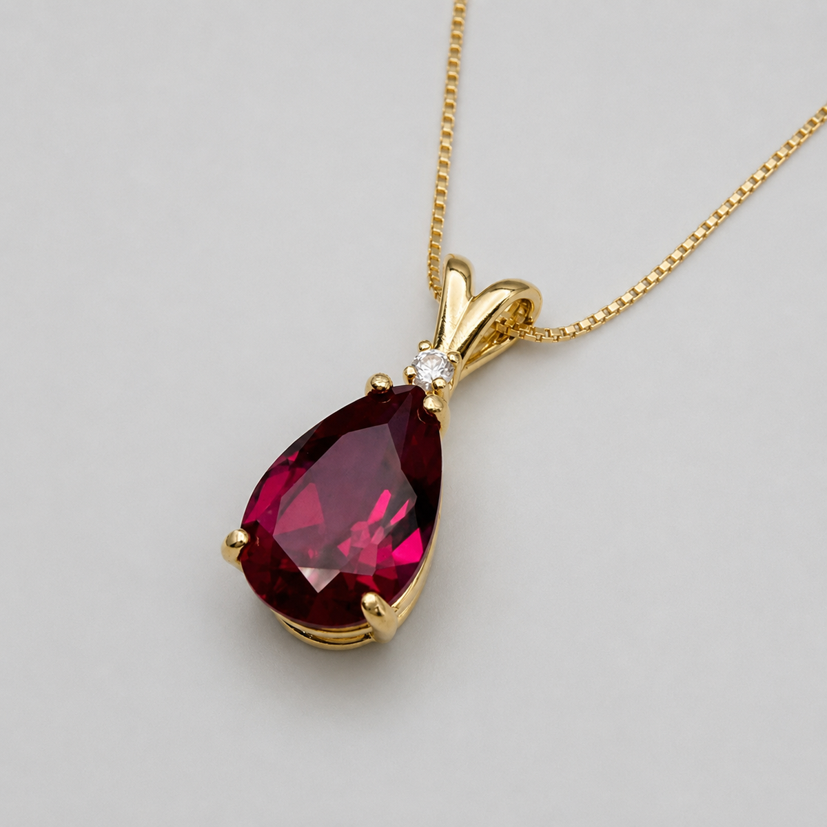 7.5ct Pear Cut Ruby Pendant Necklace with Diamond Accent in 14k Gold