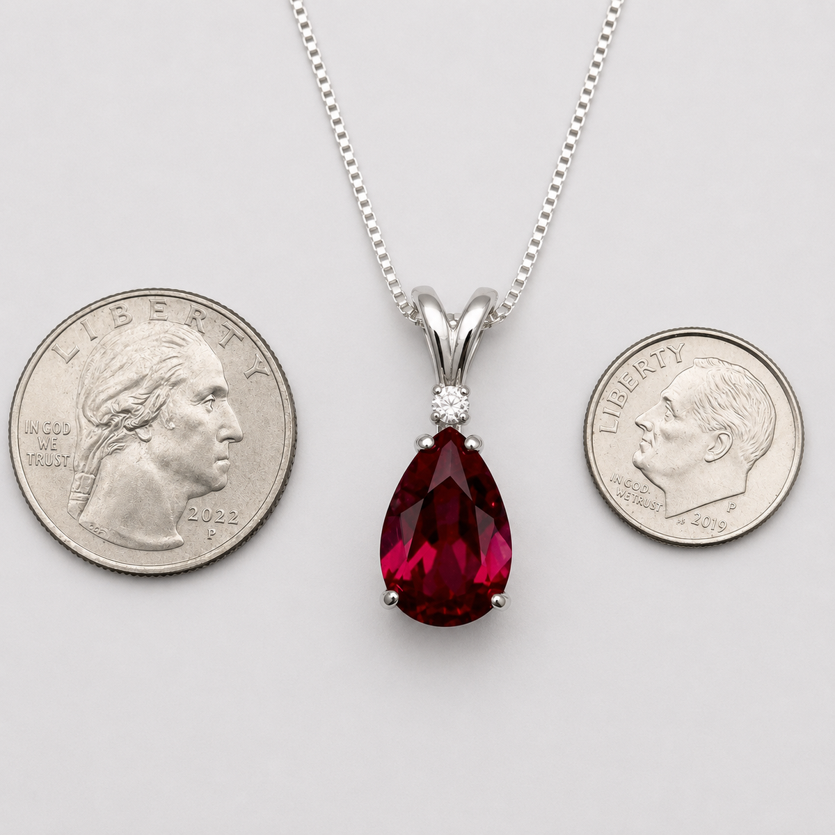7.5ct Pear Cut Ruby Pendant Necklace with White Sapphire Accent in Sterling Silver