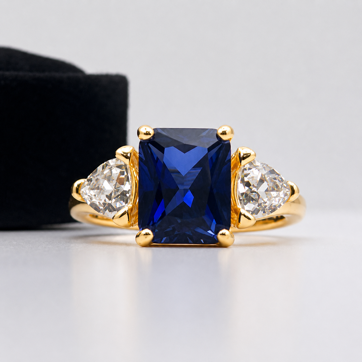 5.5ctw Emerald Cut Blue Sapphire Ring with Trillion Cut Side Stones