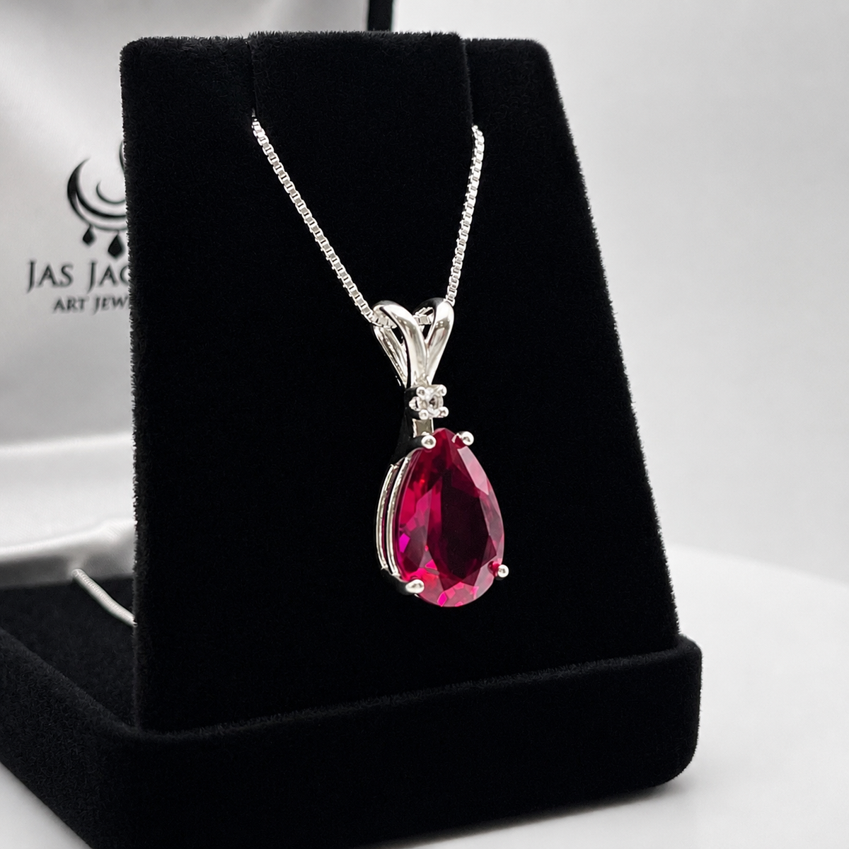 7.5ct Pear Cut Ruby Pendant Necklace with White Sapphire Accent in Sterling Silver
