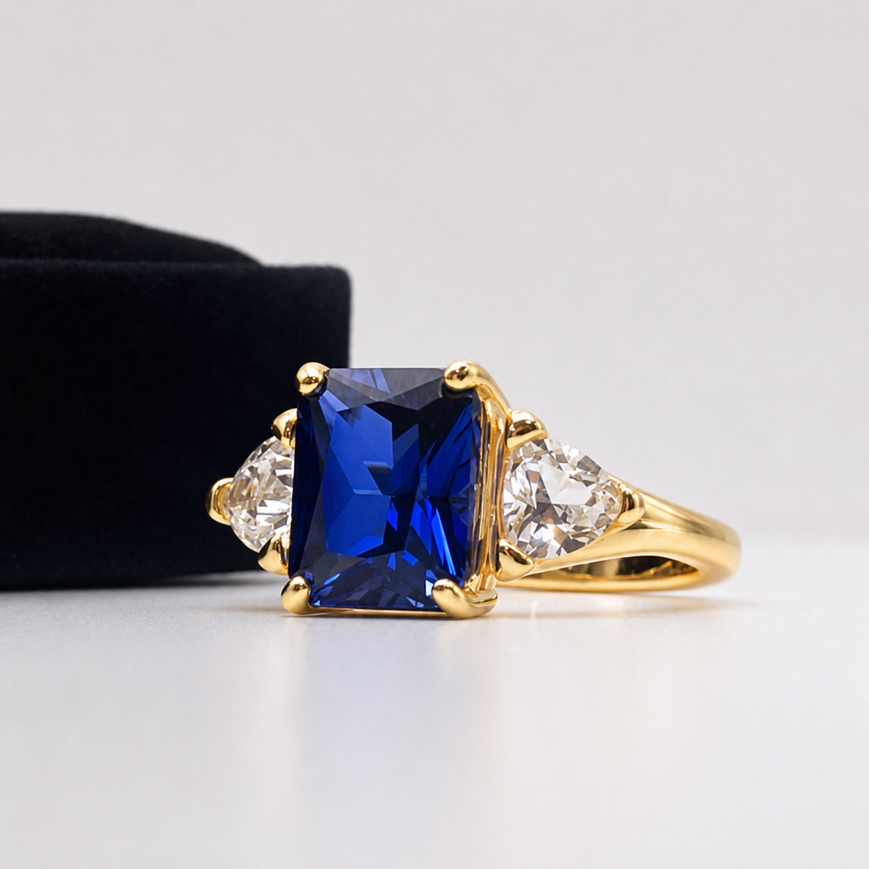 5.5ctw Emerald Cut Blue Sapphire Ring with Trillion Cut Side Stones
