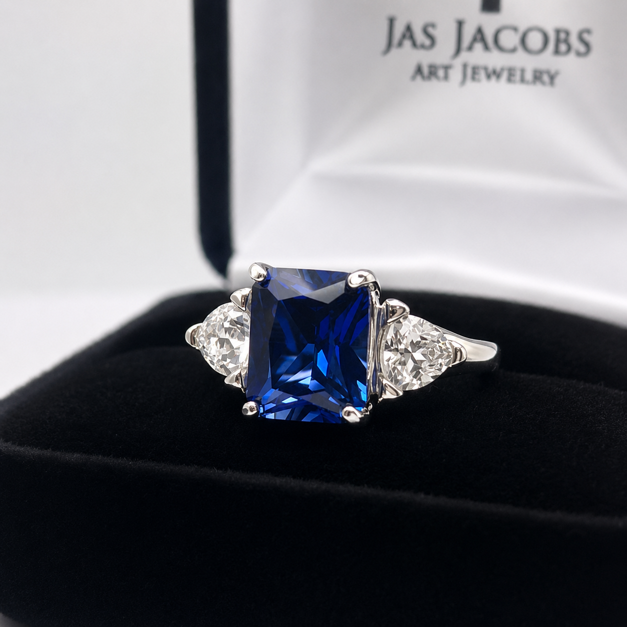 5.5ctw Emerald Cut Blue Sapphire Ring with Trillion Cut Side Stones