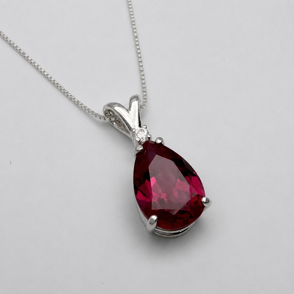 7.5ct Pear Cut Ruby Pendant Necklace with Diamond Accent in 14k Gold
